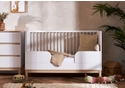 Contemporary cot bed in a white and natural finish. Three mattress base heights. Transforms to a toddler bed.