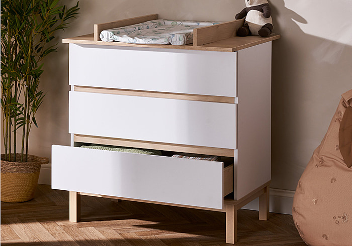 Modern, white and natural finish 3 drawer changing unit. Transforms to a flat top drawer chest when changing area is no longer needed.