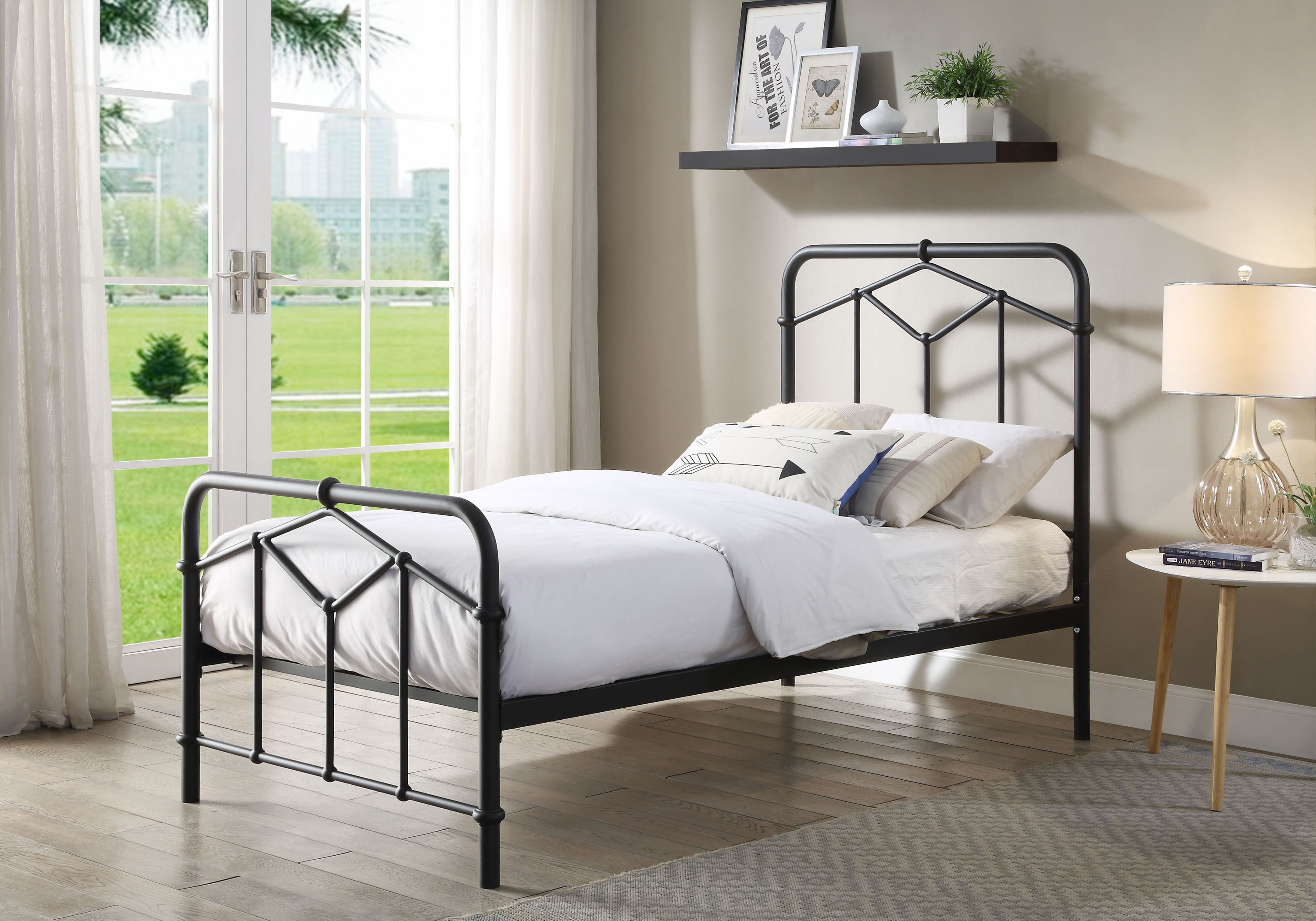 Black metal frame bed with white bedsheets