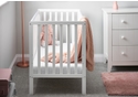 White wooden cot with open an open slat design. Includes teething rails and 3 height position base.