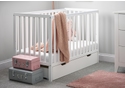 White wooden cot with pull out under drawer on castors. Teething rails included. Open slat design.