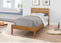 A contemporary style wooden bed frame, horizontal slatted headboard and tapered legs