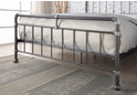 Contemporary, industrial style metal bed frame with pipe joint detailing and a rugged textured look.
