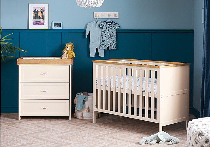 Modern 2 piece room set in cashmere with wood. Comprises 2 drawer changing unit and mini cot bed.