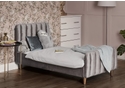 A luxurious grey velvet toddler bed frame with a deep padded headboard and footboard. Tapered gold legs.