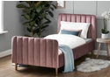 A luxurious pink velvet single bed frame with a deep padded headboard and footboard. Tapered gold legs.