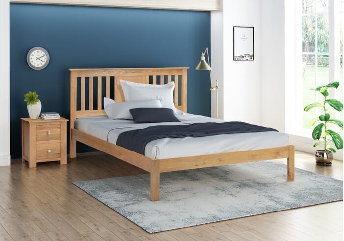 Modern solid oak bed frame with a natural finish. Low foot end and slatted headboard. Wood slatted base.