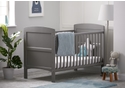Taupe grey cot bed with open slatted sides, solid end panels and 3 height positions. Teething rails included.