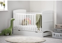 White cot bed with under drawer, open slatted sides, solid end panels and 3 height positions. Teething rails included.