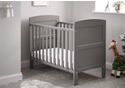 Stylish taupe grey wooden cot bed with open slatted sides and solid curved end panels. Includes teething rails.