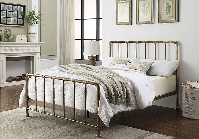 Industrial style metal bed frame with a distressed antique bronze finish. Has pipe joint detailing to the headboard and foot end.