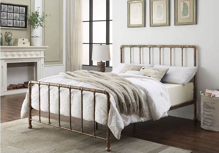 Industrial style metal bed frame with a distressed antique bronze finish. Has pipe joint detailing to the headboard and foot end.