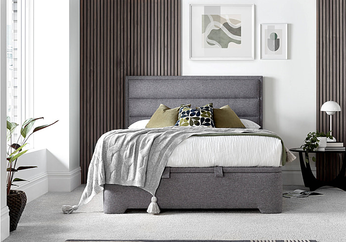 A luxurious contemporary ottoman bed frame with a modern horizontal padded headboard in grey fabric