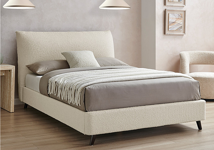 Contemporary ivory boucle fabric bed frame with a pillow back headboard. Low foot end and stylish angled dark feet.