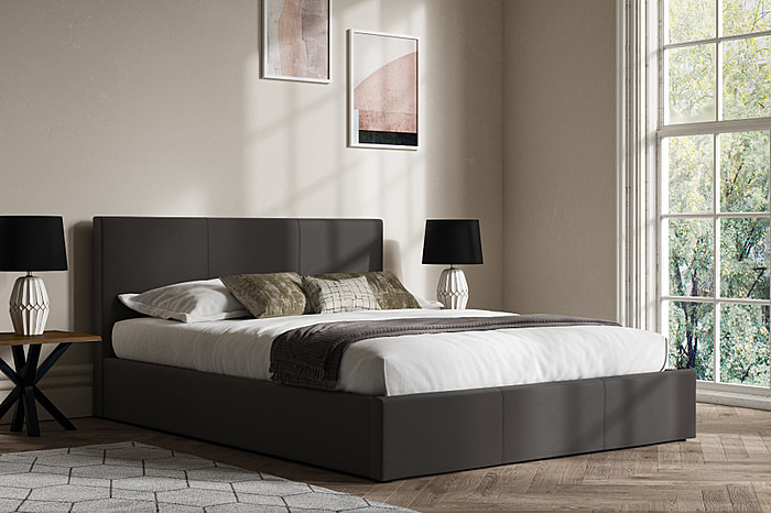 Contemporary grey faux leather ottoman bed frame.