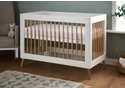 Scandinavian style mini cot bed with a white and natural finish. 3 base height positions. Transforms to a junior bed.