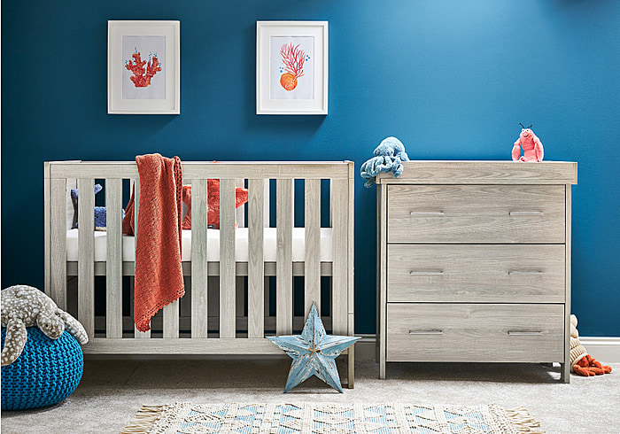 Cot bed and changing unit with 3 drawers in a modern grey wash finish. Cot has 3 base heights and teething rails.