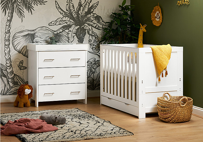 Cot bed with under drawer and 3 drawer changing unit. White wash finish. Cot has 3 base levels and teething rails.