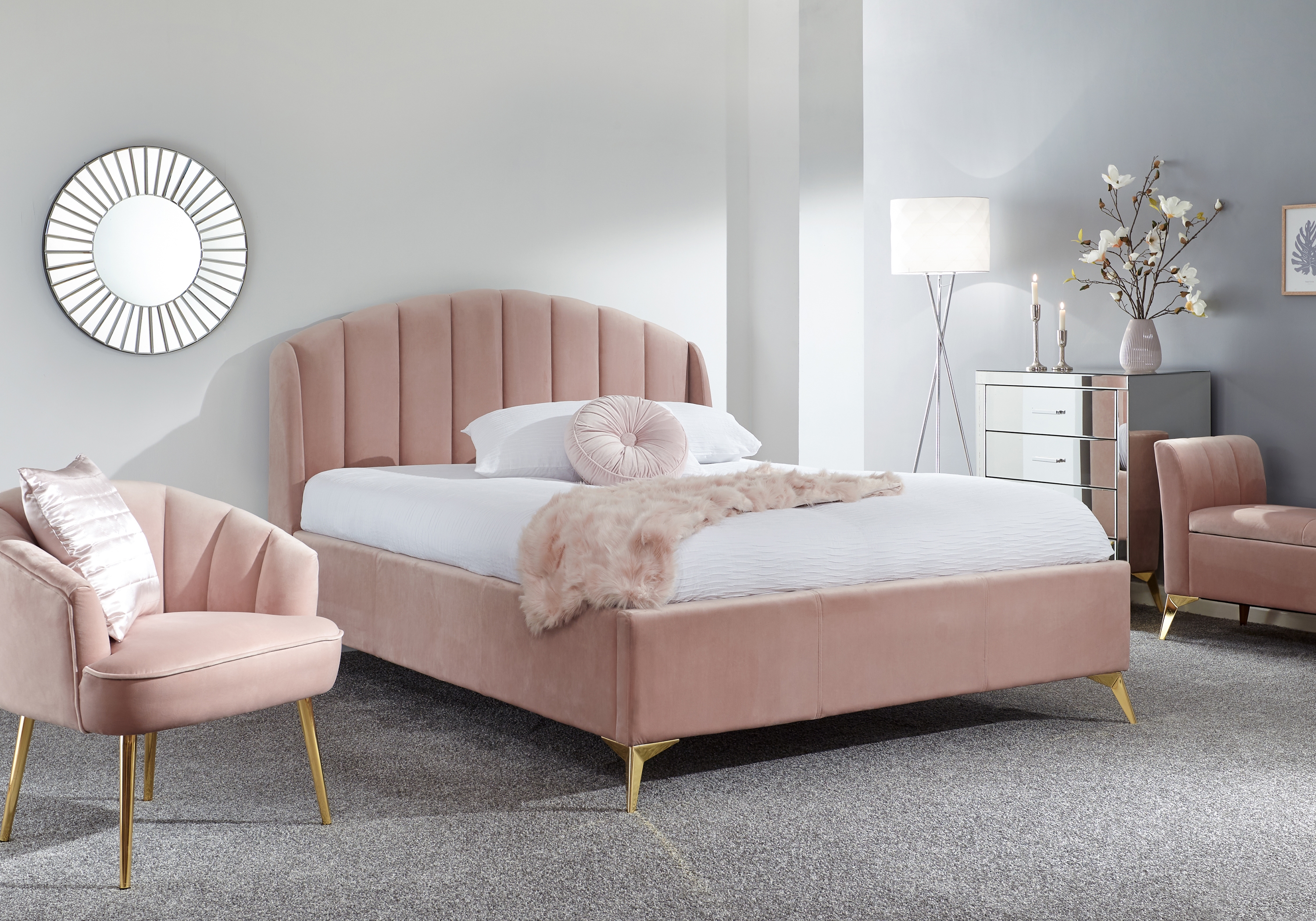 Pink ottoman double bed in grey bedroom with pink furniture