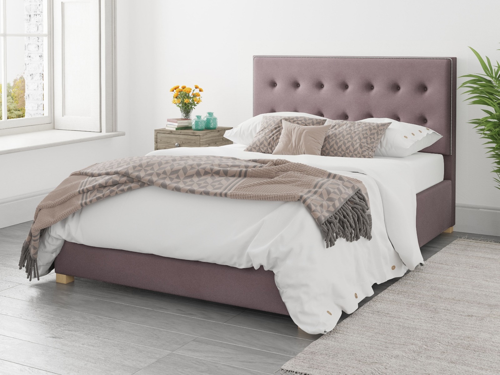 Pink ottoman double bed with brown and white sheets