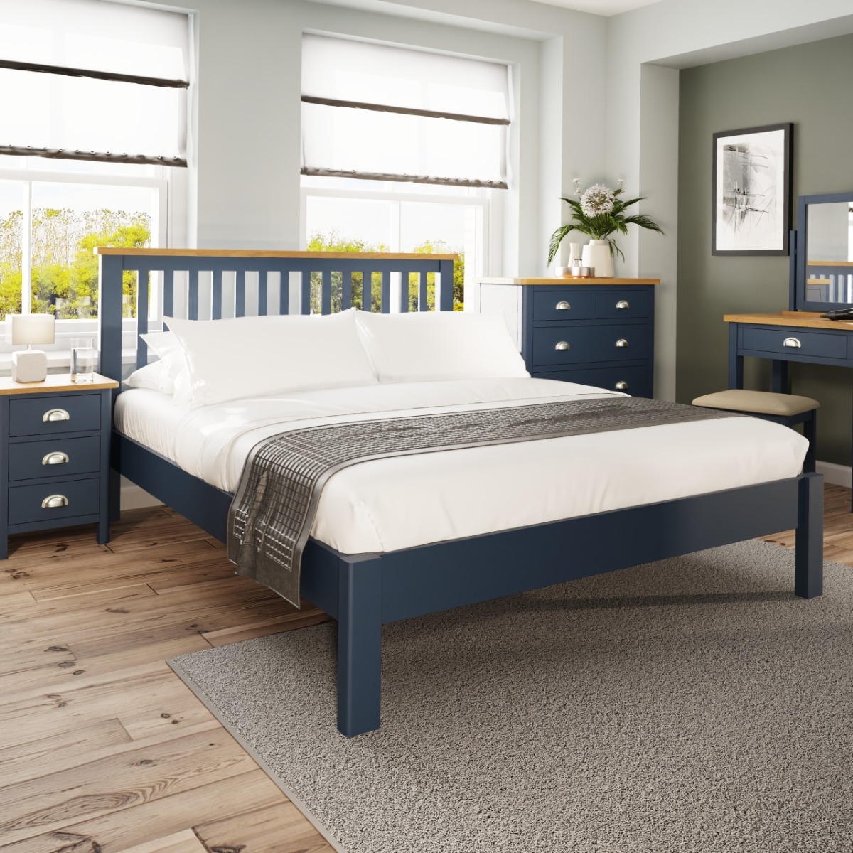 Blue wooden double bed with white and grey bedsheets