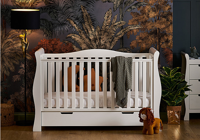 A luxurious white sleigh style cot bed with drawer. Can be a cot, toddler bed and day bed. 3 Mattress base heights, teething rails.