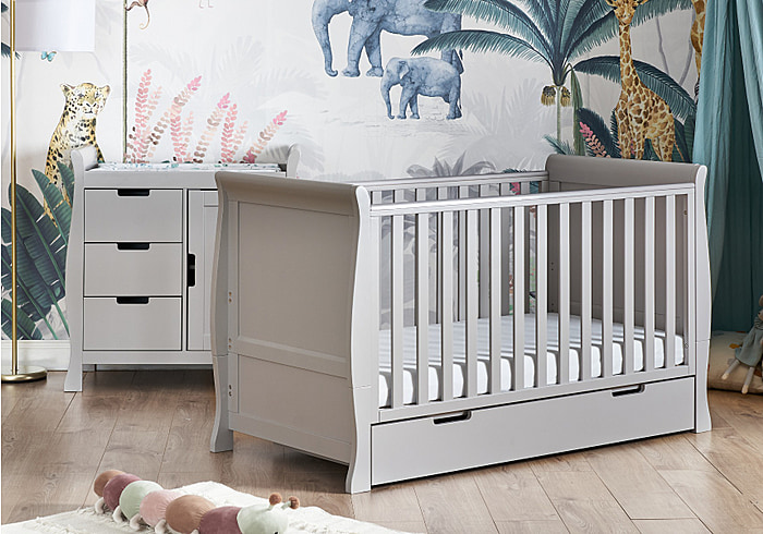 Grey Classic sleigh style cot bed with drawer and changing unit with storage.