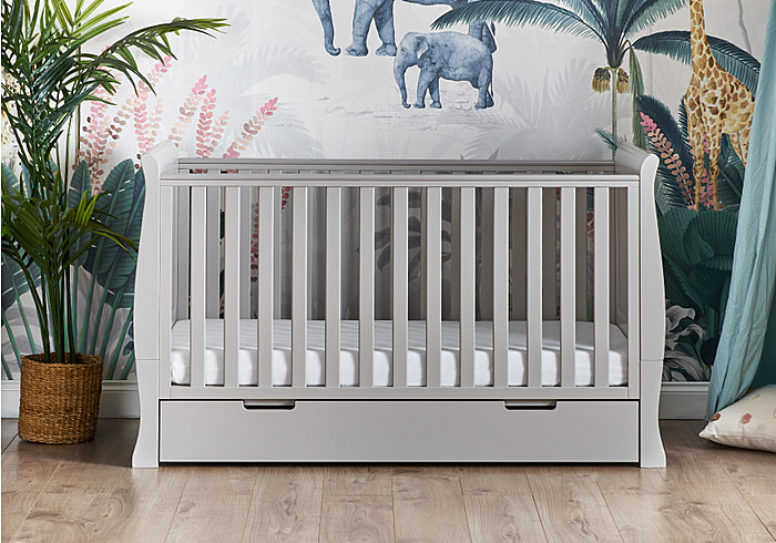 Grey traditional sleigh design cot bed with under drawer. Open slatted sides, 3 position base height and teething rails.