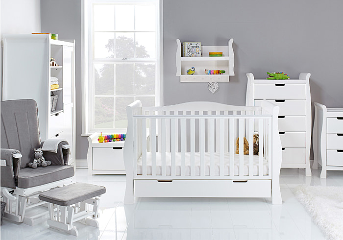 Luxury white 7 piece room set in an elegant sleigh design. Cot bed, tall drawers, changing unit, double wardrobe, toy box, shelf and glider chair.
