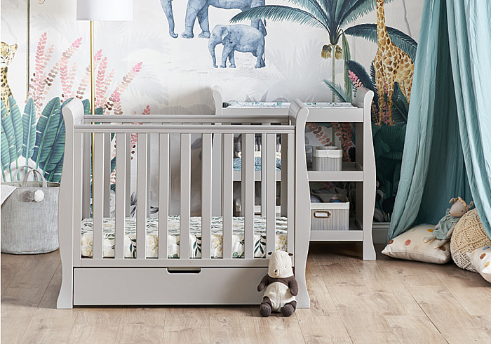 Elegant sleigh design grey 2 piece nursery room set. Cot bed with drawer and open changing unit.