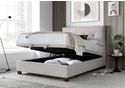 Luxurious pale cream fabric ottoman bed frame with modern dark wooden feet.