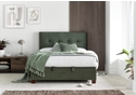 Luxurious moss green velvet ottoman bed frame with modern dark wooden feet.