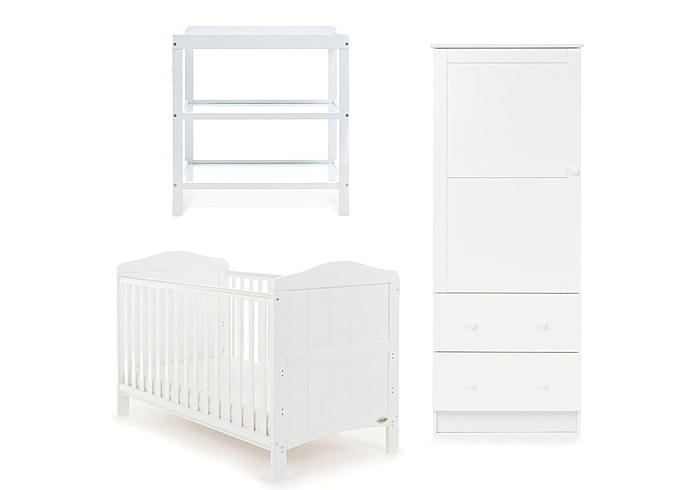 White wooden coastal themed cot bed, white open changing unit and single wardrobe