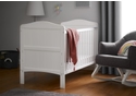 Beautiful coastal themed white wooden cot bed with grooved end panels with gentle curves. Includes teething rails.