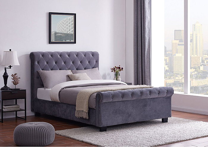 An elegant Chesterfield style ottoman bed frame upholstered in a plush grey fabric.